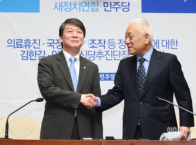 악수 나누는 안철수 새정치연합 중앙운영위원장(사진 왼쪽)과 민주당 김한길 대표