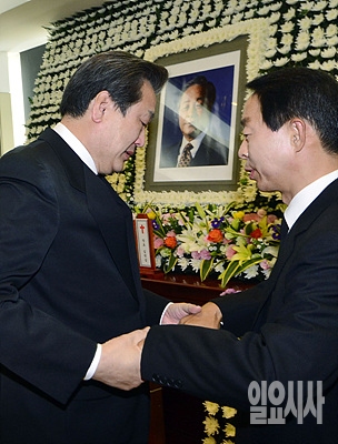 고 김영삼 전 대통령 조문 도중 악수 나누는 김무성 새누리당 대표(사진 왼쪽)과 차남 현철씨 <사진공동취재단>